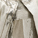 Evening dress of embroidered net and matelasse coat