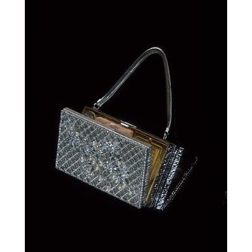 Handbag with powder puff and lipstick