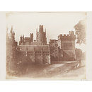 Margam Castle with a man recling on a grass bank (Photograph)