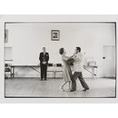 Ballroom dancing teacher, Ted van Rensburg, watches two of his pupils swinging to the music of Victor Sylvester and his orchestra, in the old Court House, Boksburg. (Photograph)