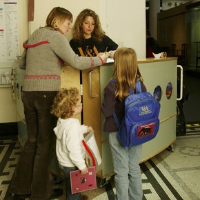 A family borrowing a V&A activity backpack.