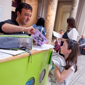 A family borrowing a V&A activity backpack.