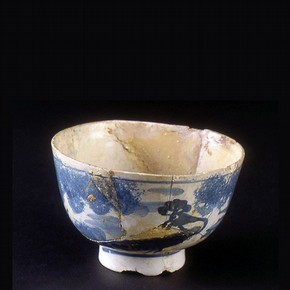 A poorly repaired English tin glazed earthenware bowl, late 17th to mid 18th century.