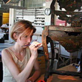 Museum conservator working on a chair