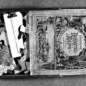 Figure 1. View of partially opened box showing an 1870 map jigsaw puzzle of England and Wales