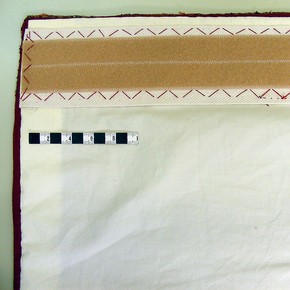 A conserved carpet with cotton lining and Velcro attached ready for hanging.