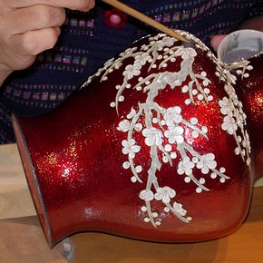 Applying enamel paste to a vase. Photograph courtesy Gregory Irvine