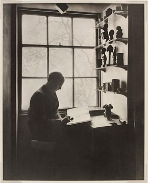 Curtis Moffat in his studio at Fitzroy Square with African sculptures, about 1930. Museum no. E.881-2003