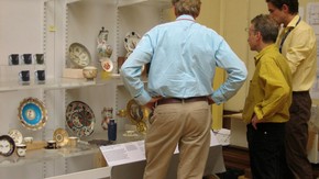 Curators discussing a 'mock up' of a display